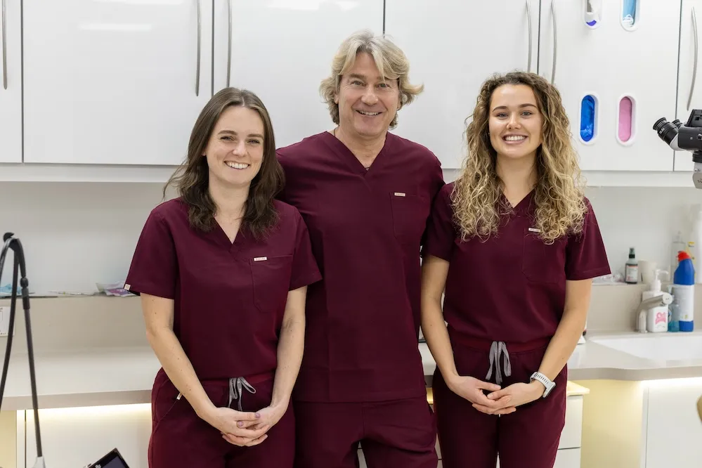 Three members of the Broad Street Dental team standing together in a treatment room in St Helier