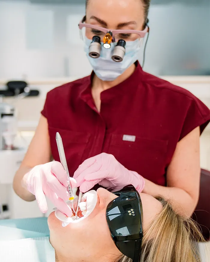 A Broad Street Dental clinician wearing loupes treating a patient in the chair