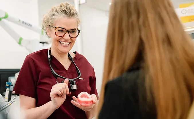 A Broad Street Dental dentist chatting with a patient during a consultation