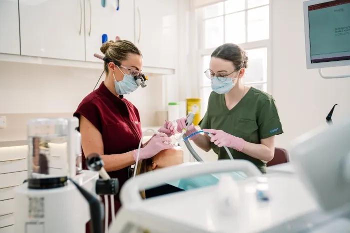 A hygienist and dental nurse carrying out a hygiene treatment at Broad Street Dental