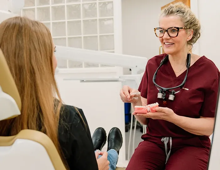 A Broad Street Dental dentist talking a patient through Invisalign aligners