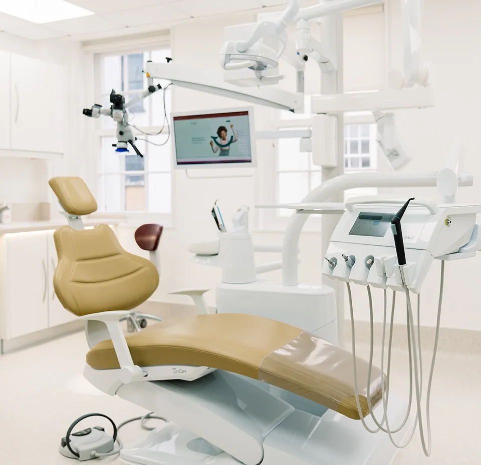 A bright treatment room at Broad Street Dental with the dental chair and overhead light